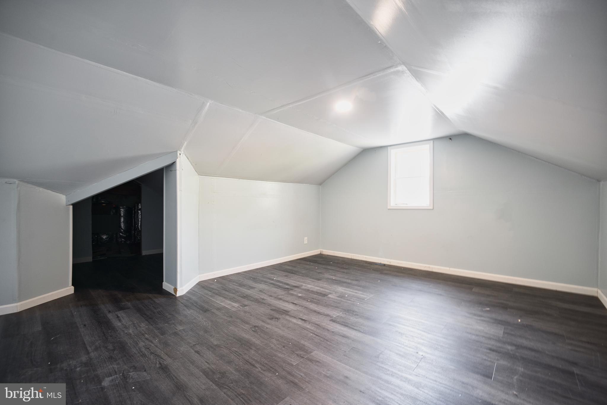 100 9th Avenue Baltimore, MD 21225 - Photo 27 of 38 an empty room with wooden floor and windows