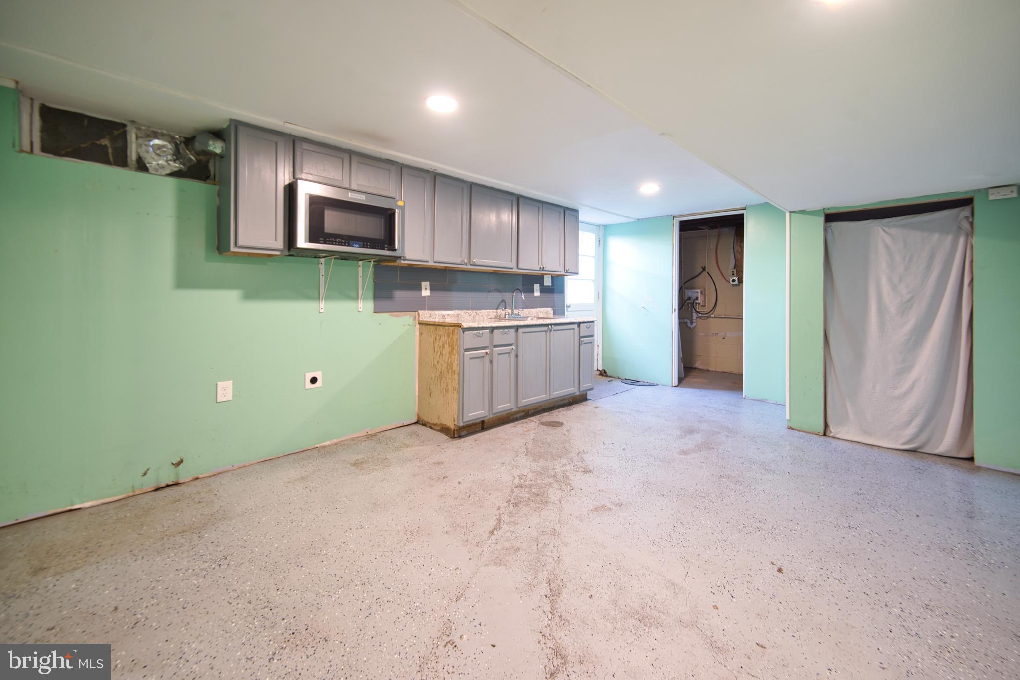 100 9th Avenue Baltimore, MD 21225 - Photo 38 of 38 a view of a kitchen with a sink cabinets and a kitchen