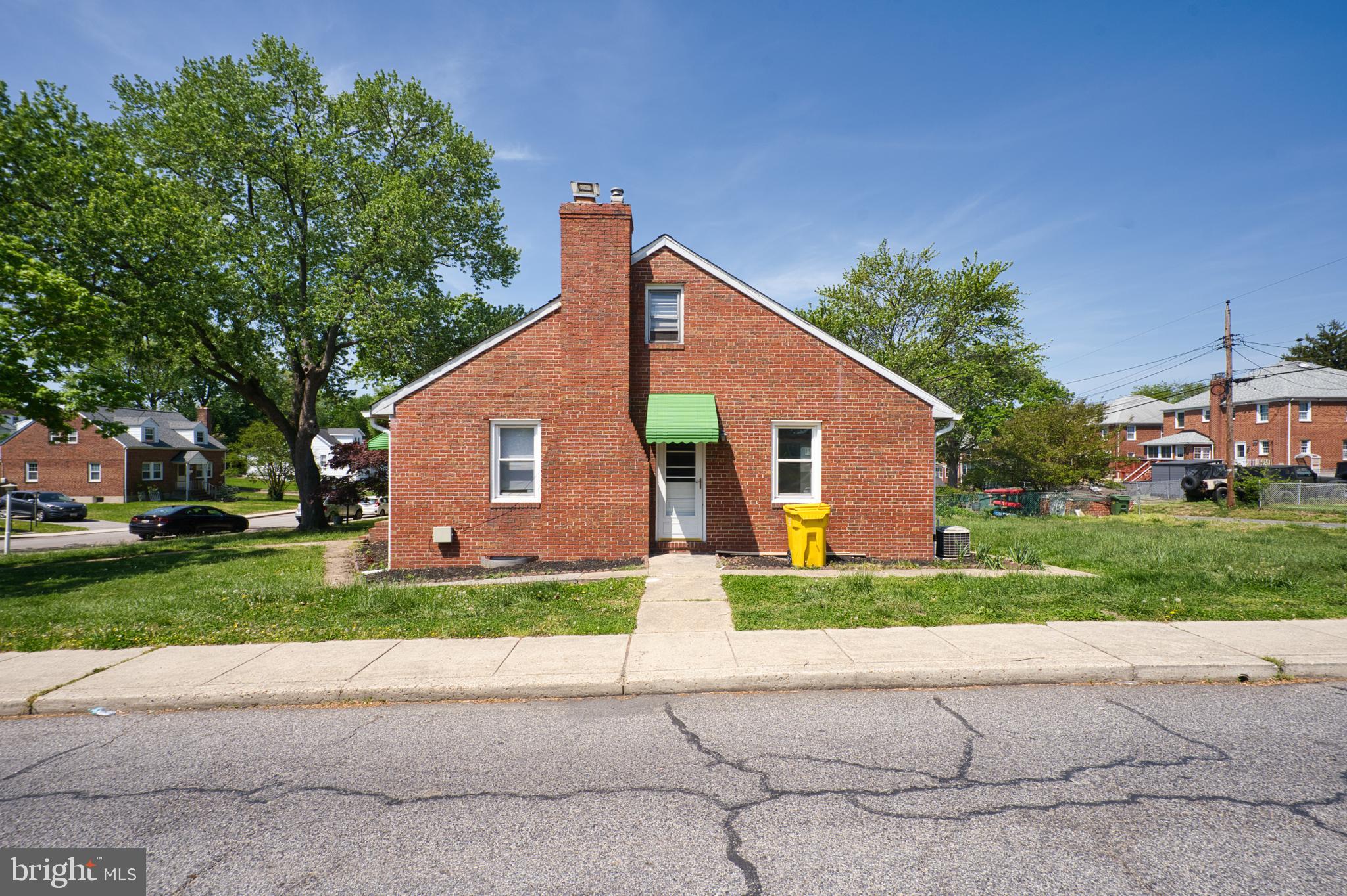 100 9th Avenue Baltimore, MD 21225 - Photo 4 of 38 a front view of a house with a yard and garage