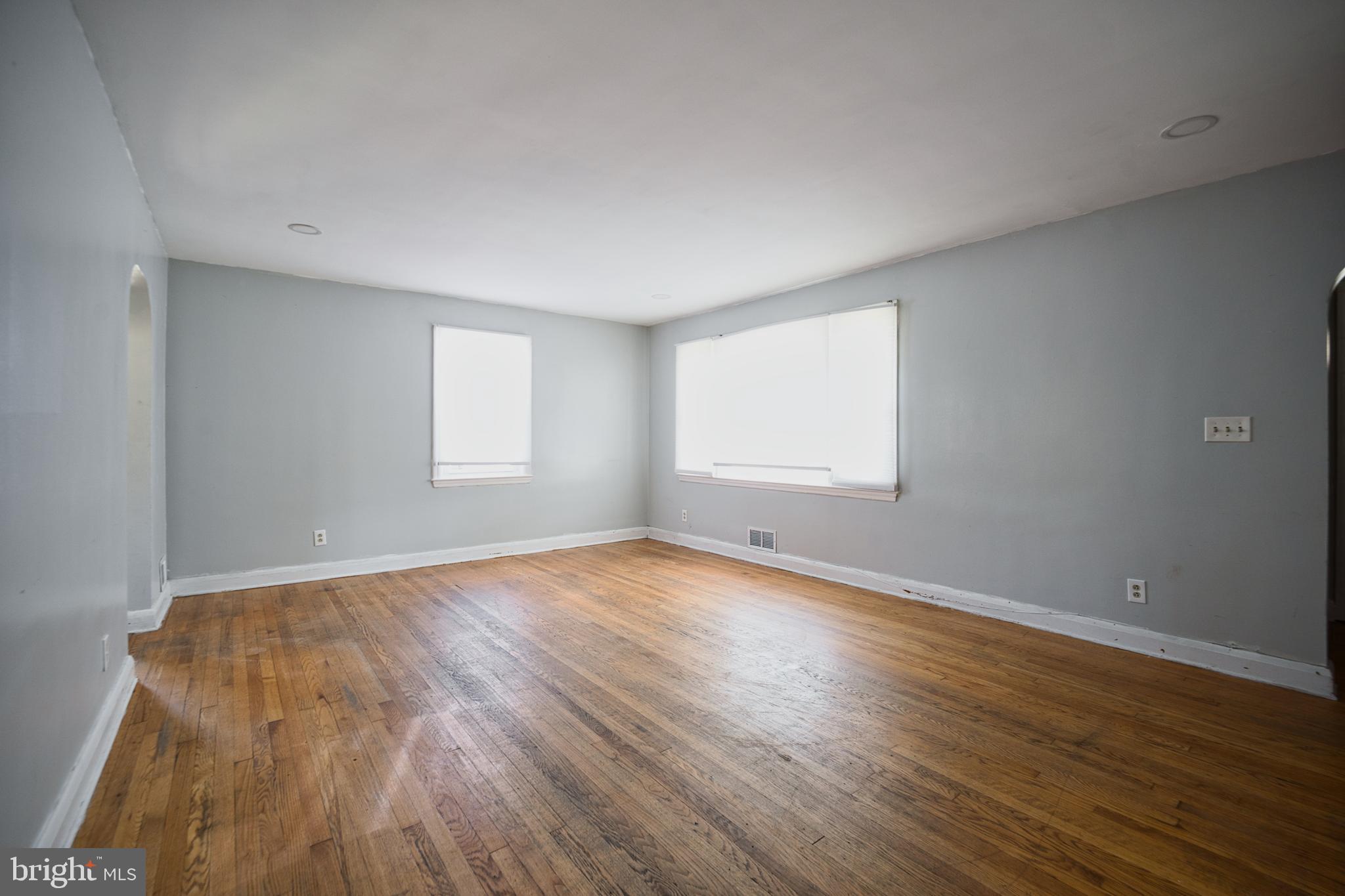 100 9th Avenue Baltimore, MD 21225 - Photo 9 of 38 an empty room with wooden floor and windows