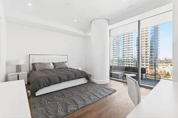 a bedroom with a large bed and a couch