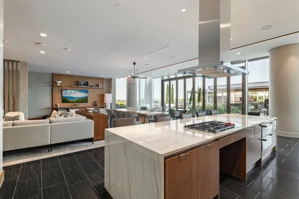 a open kitchen with stainless steel appliances kitchen island granite countertop a stove and a sink