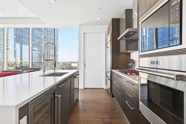 a kitchen with stainless steel appliances granite countertop a sink stove and refrigerator