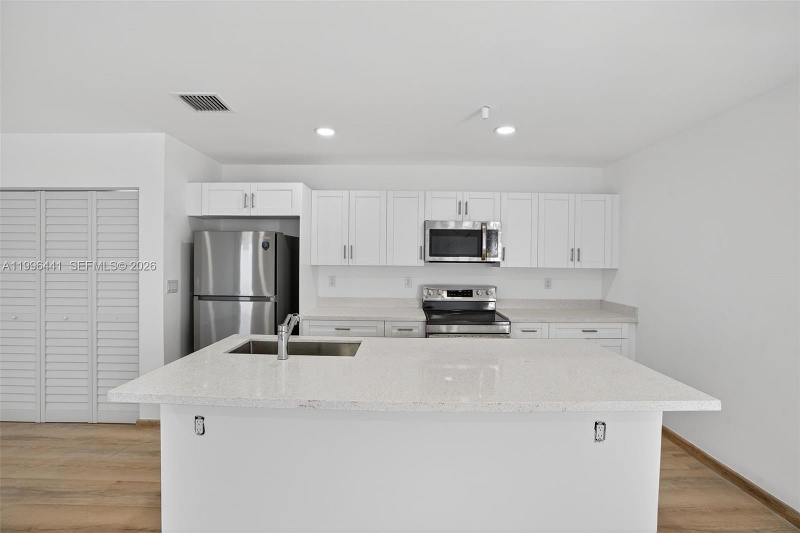 1515 Redland Road, Unit 1 Florida City, FL 33034 - Photo 2 of 13 a kitchen with stainless steel appliances a stove top oven a sink a refrigerator and white cabinets
