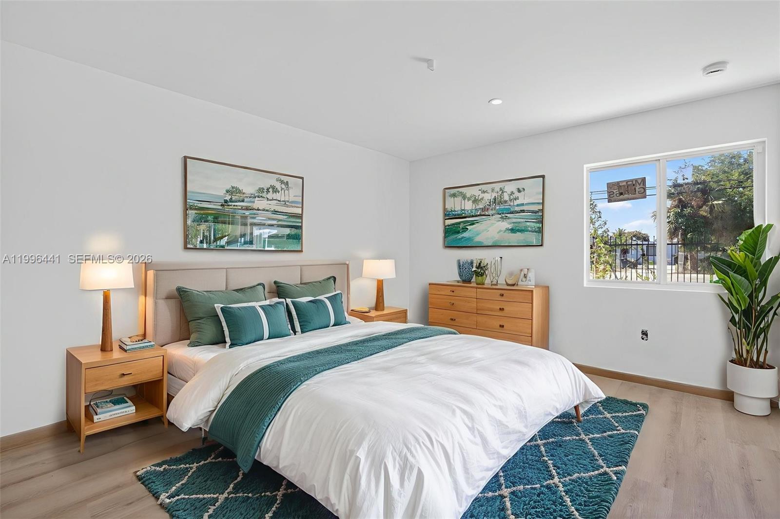 1515 Redland Road, Unit 1 Florida City, FL 33034 - Photo 3 of 13 a bedroom with a large bed and a chandelier