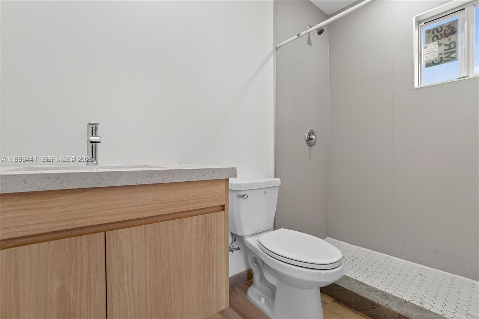 1515 Redland Road, Unit 1 Florida City, FL 33034 - Photo 4 of 13 a bathroom with a sink a toilet and a mirror
