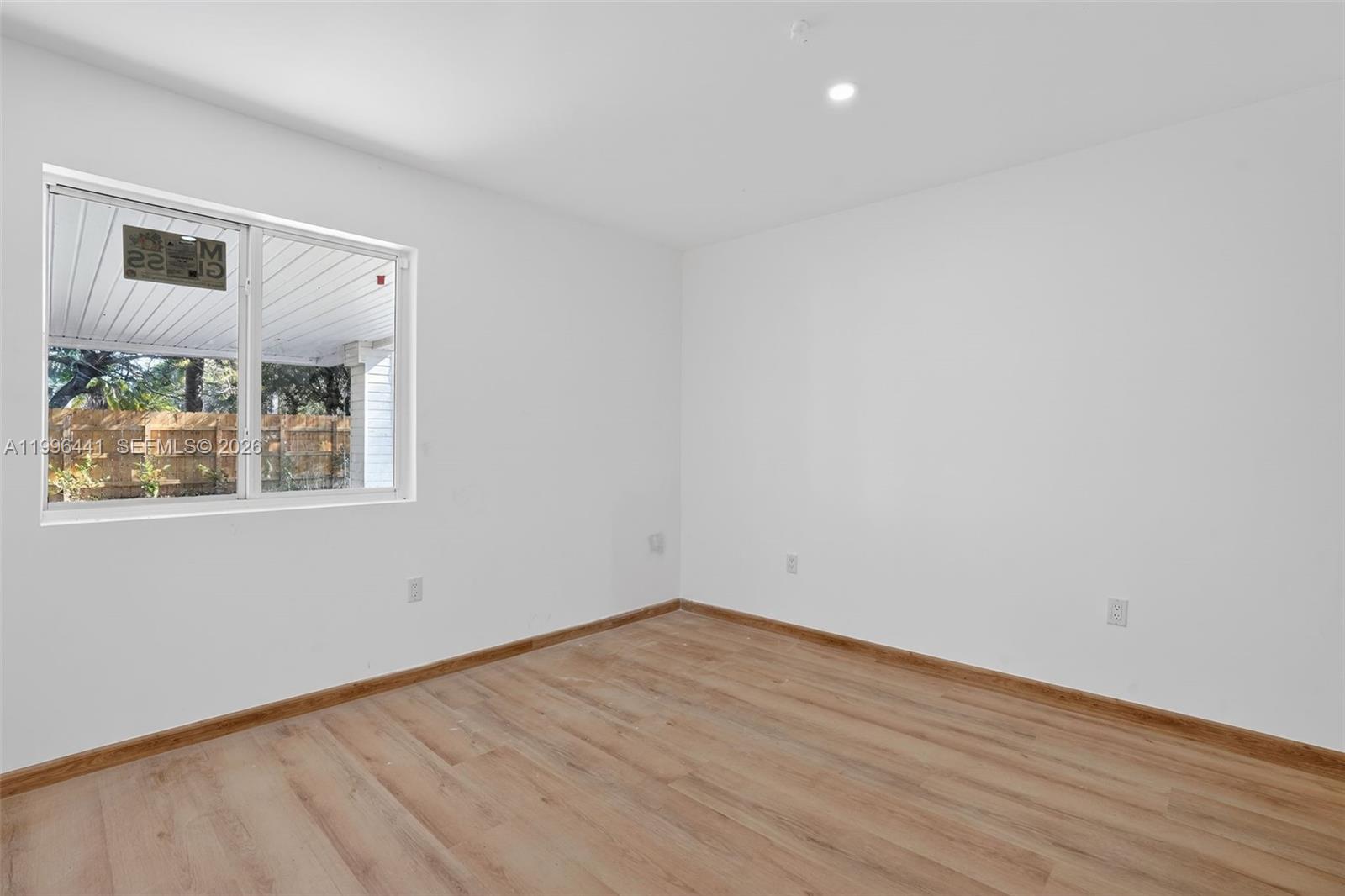 1515 Redland Road, Unit 1 Florida City, FL 33034 - Photo 5 of 13 a view of an empty room with wooden floor and a window