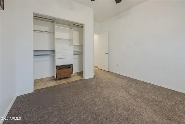 a view of an empty room with a fireplace and cabinet