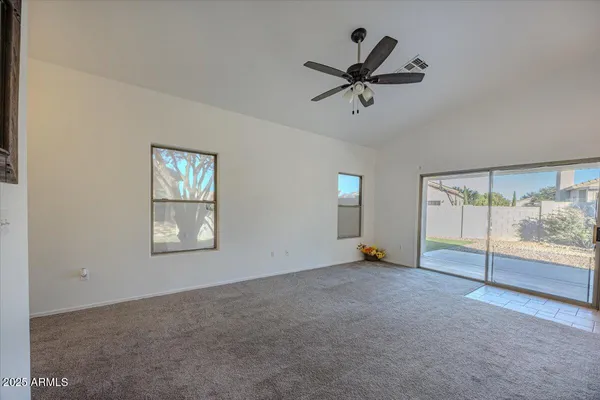a view of empty room with ceiling fan