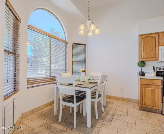 a view of a dining room with furniture and chandelier
