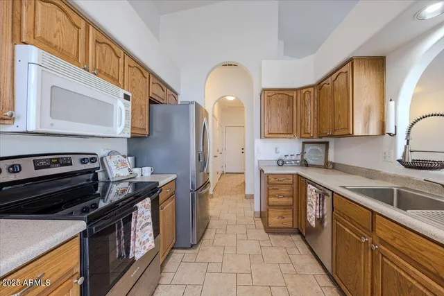 a kitchen with a stove top oven sink and cabinets