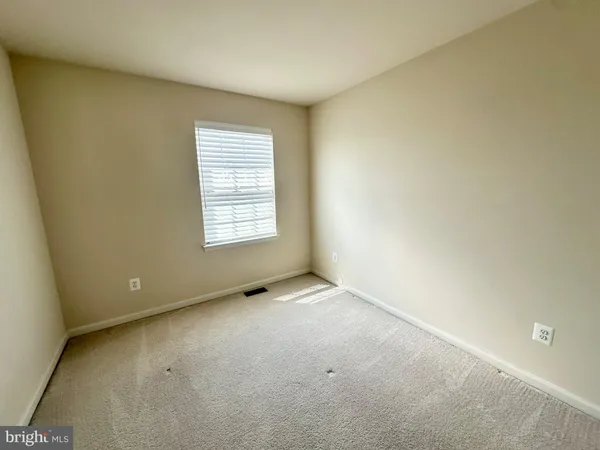 an empty room with a empty space and a window