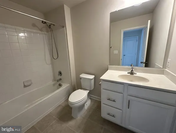 a bathroom with a granite countertop sink a toilet and shower