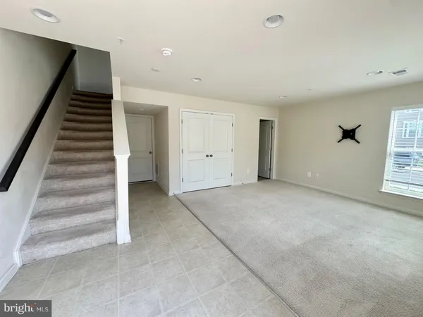 a view of an empty room with stairs