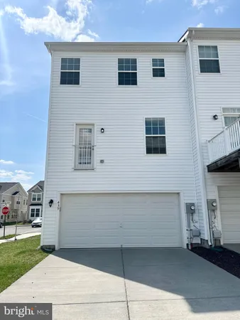 a view of a house with a barbeque and bench