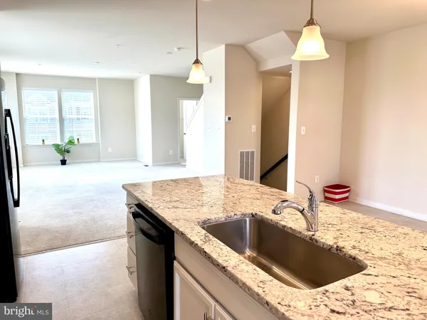 a bathroom with a sink a faucet a chandelier and a bath tub
