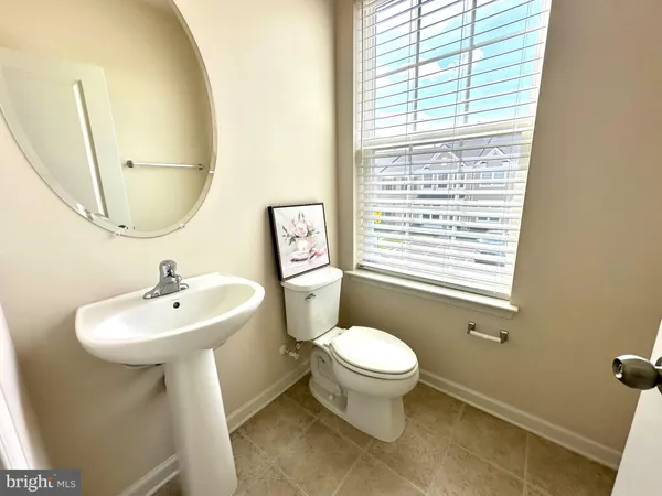a bathroom with a sink toilet and a mirror