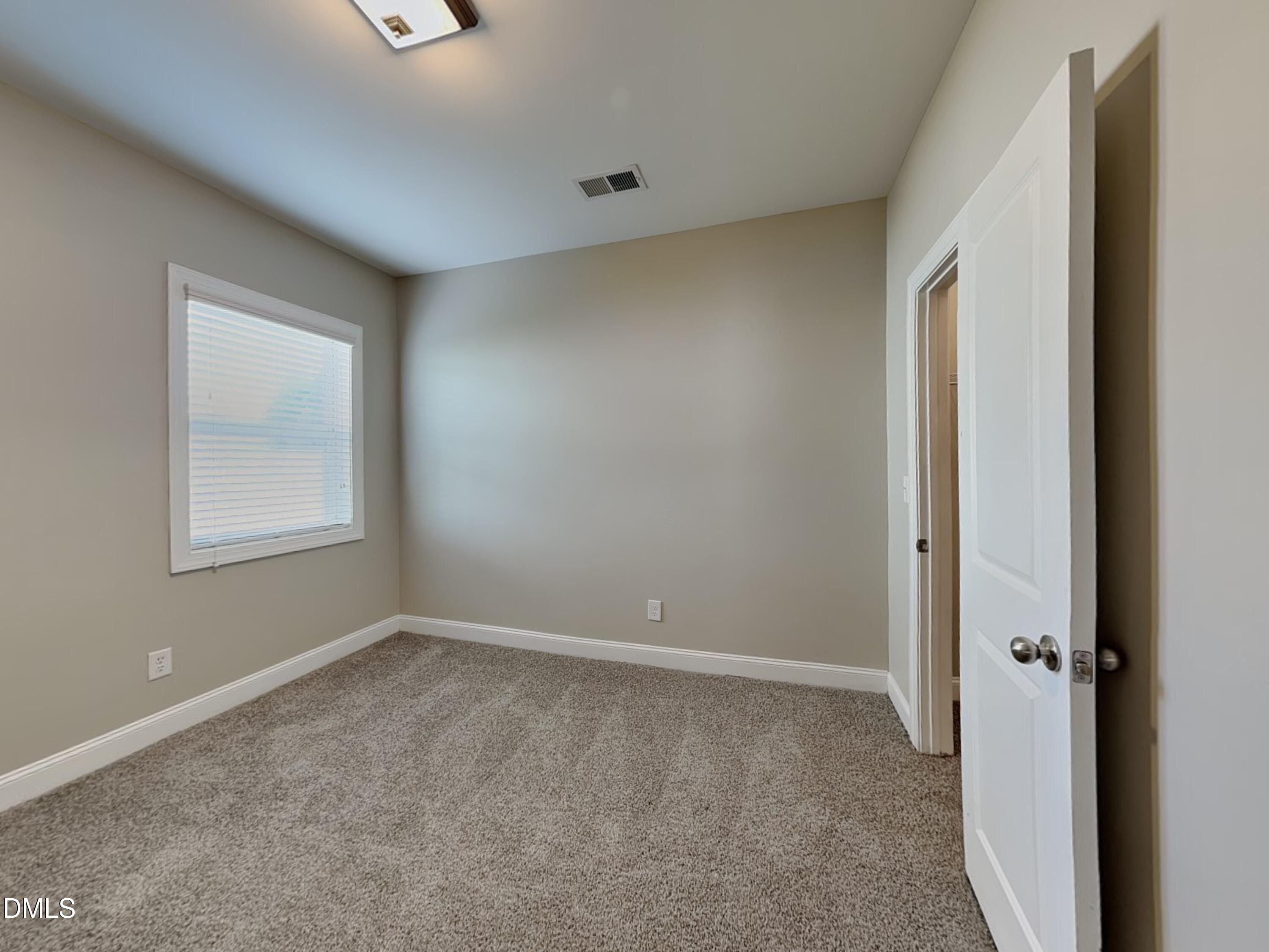 70 Leaf Spring Way Youngsville, NC 27596 - Photo 11 of 16 a view of an empty room with a window