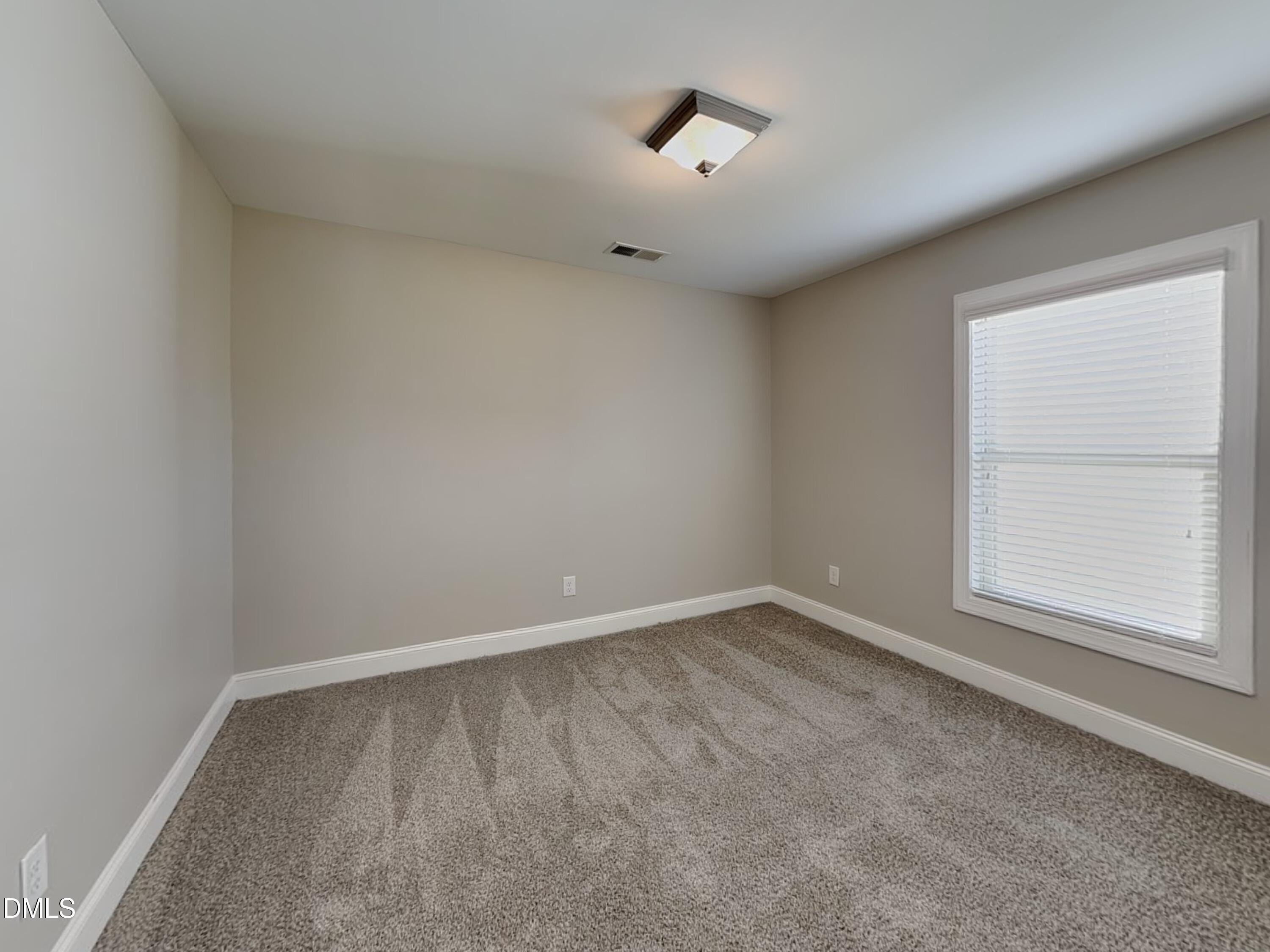 70 Leaf Spring Way Youngsville, NC 27596 - Photo 12 of 16 an empty room with a window