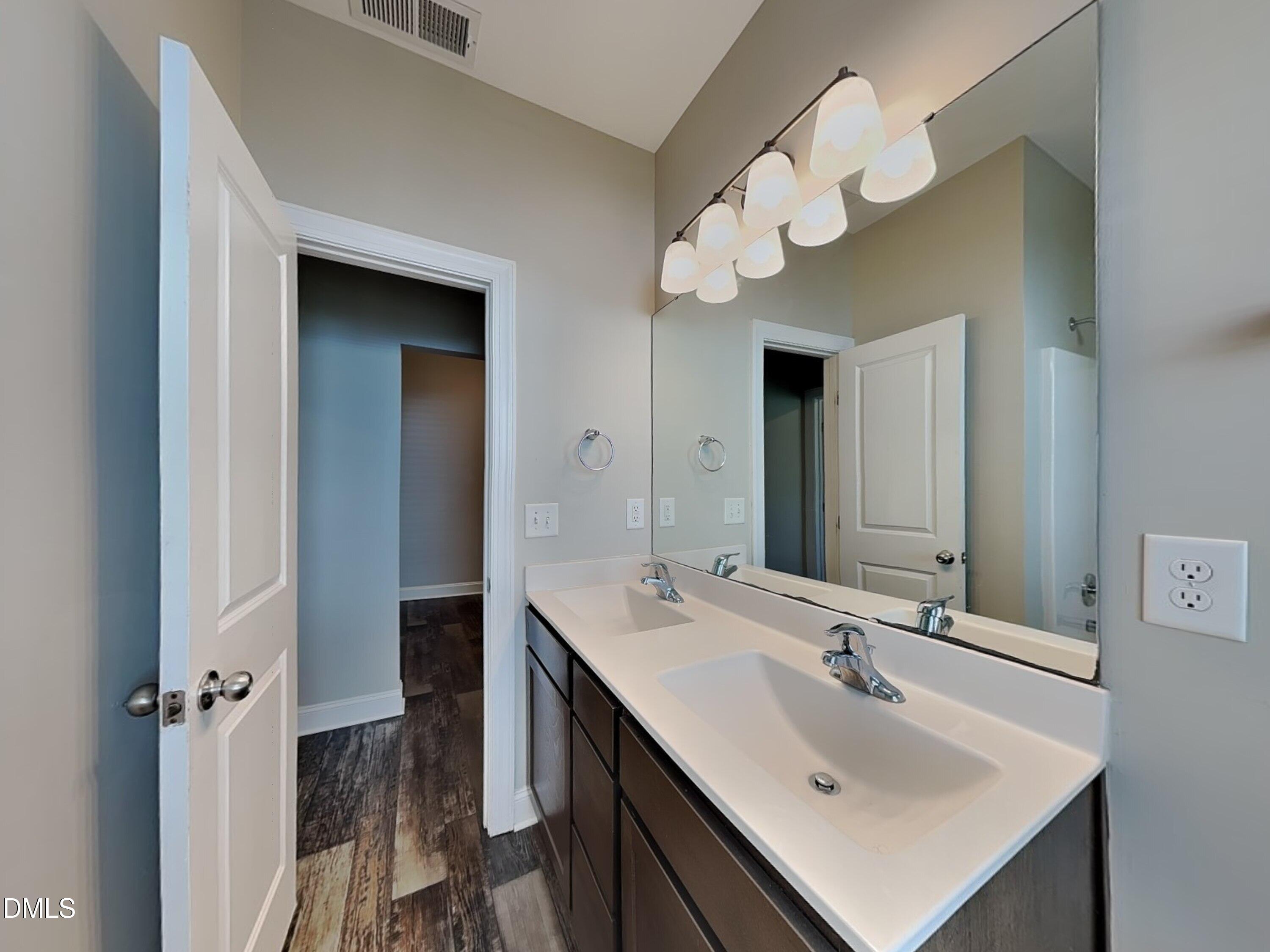 70 Leaf Spring Way Youngsville, NC 27596 - Photo 15 of 16 a bathroom with a sink and a mirror