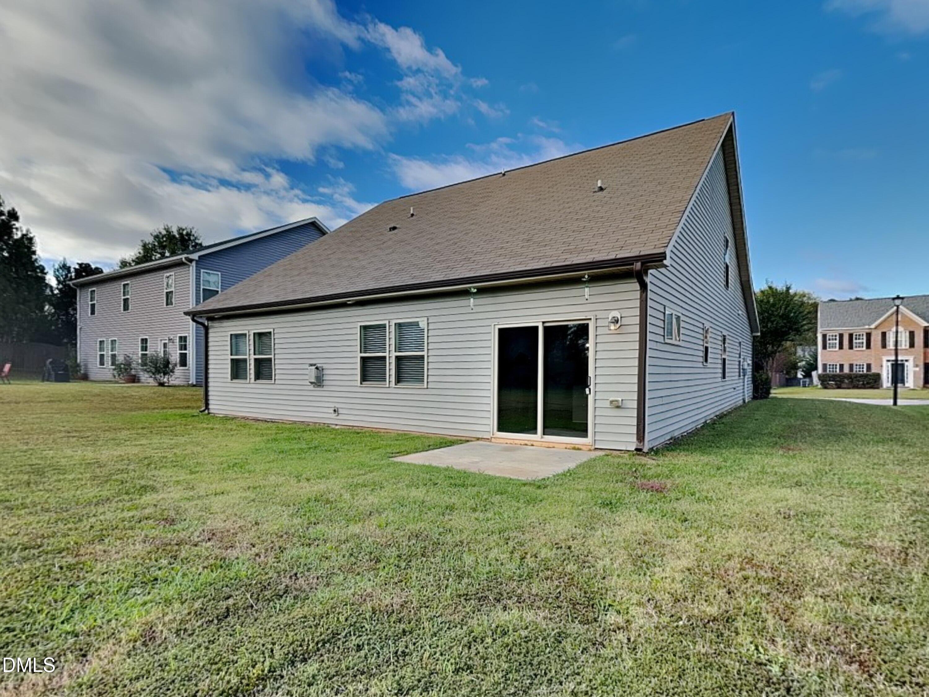 70 Leaf Spring Way Youngsville, NC 27596 - Photo 16 of 16 a front view of house with yard and trees in the background