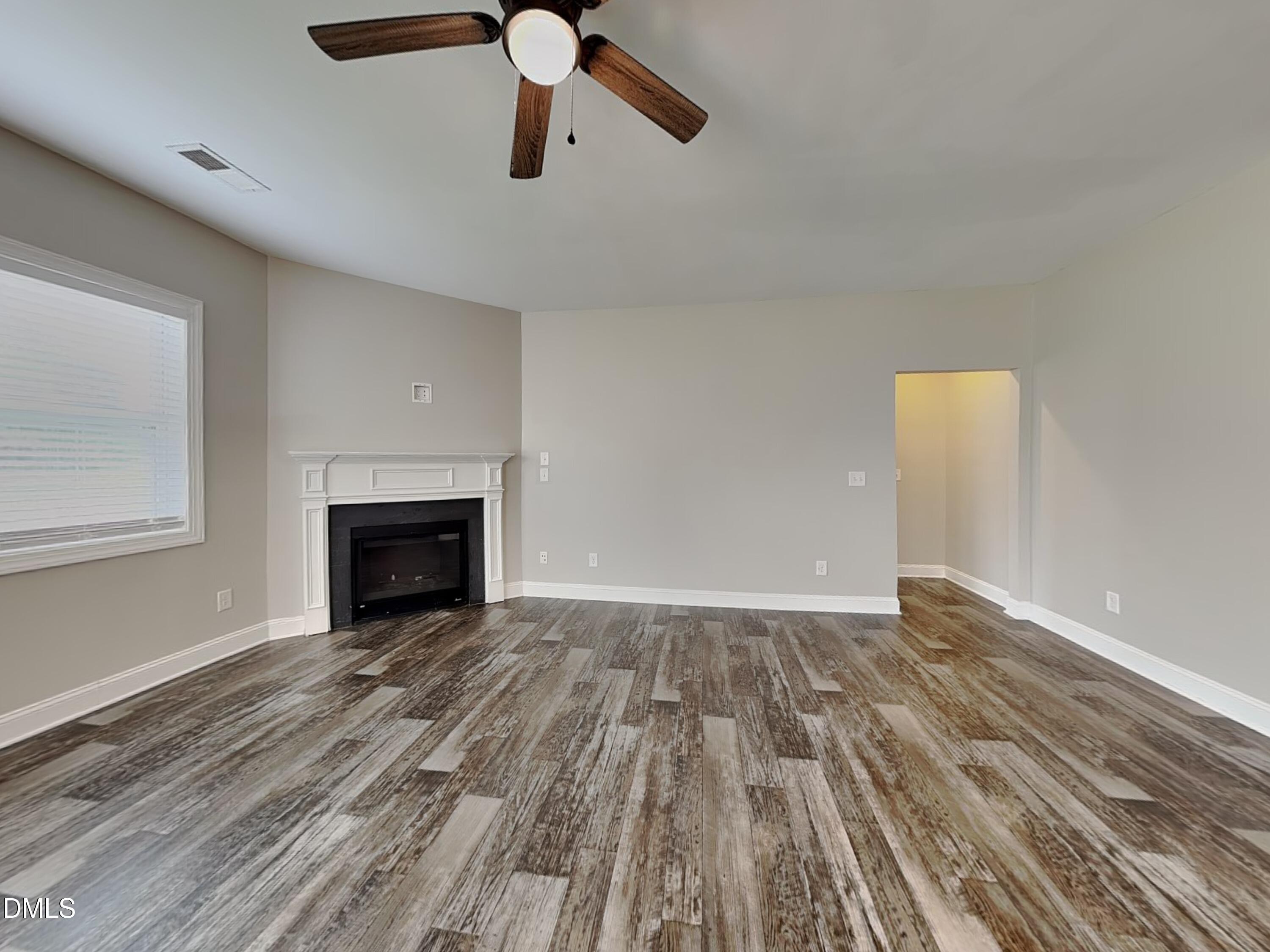 70 Leaf Spring Way Youngsville, NC 27596 - Photo 3 of 16 a view of empty room with wooden floor and fan