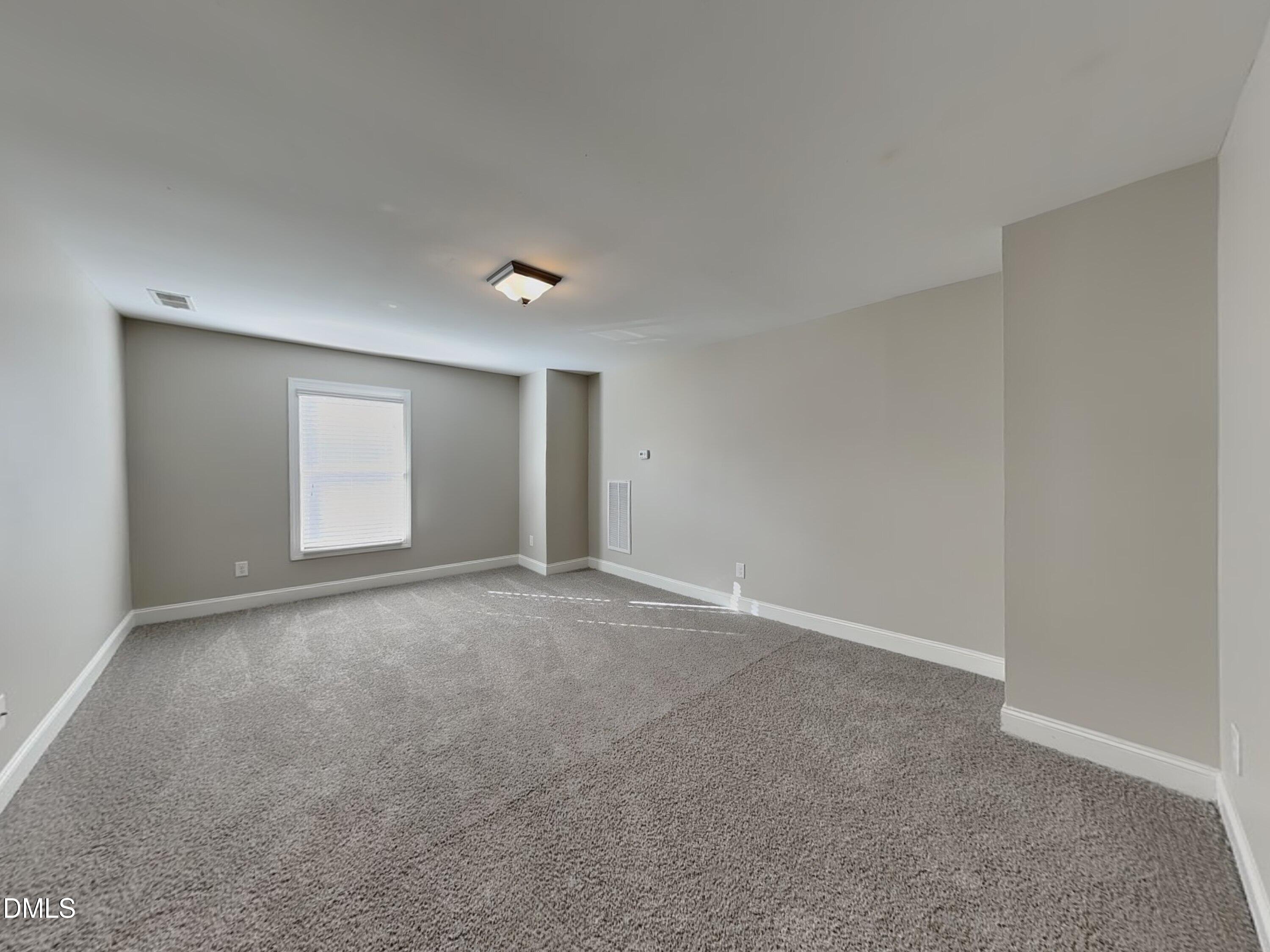 70 Leaf Spring Way Youngsville, NC 27596 - Photo 5 of 16 a view of an empty room with a window