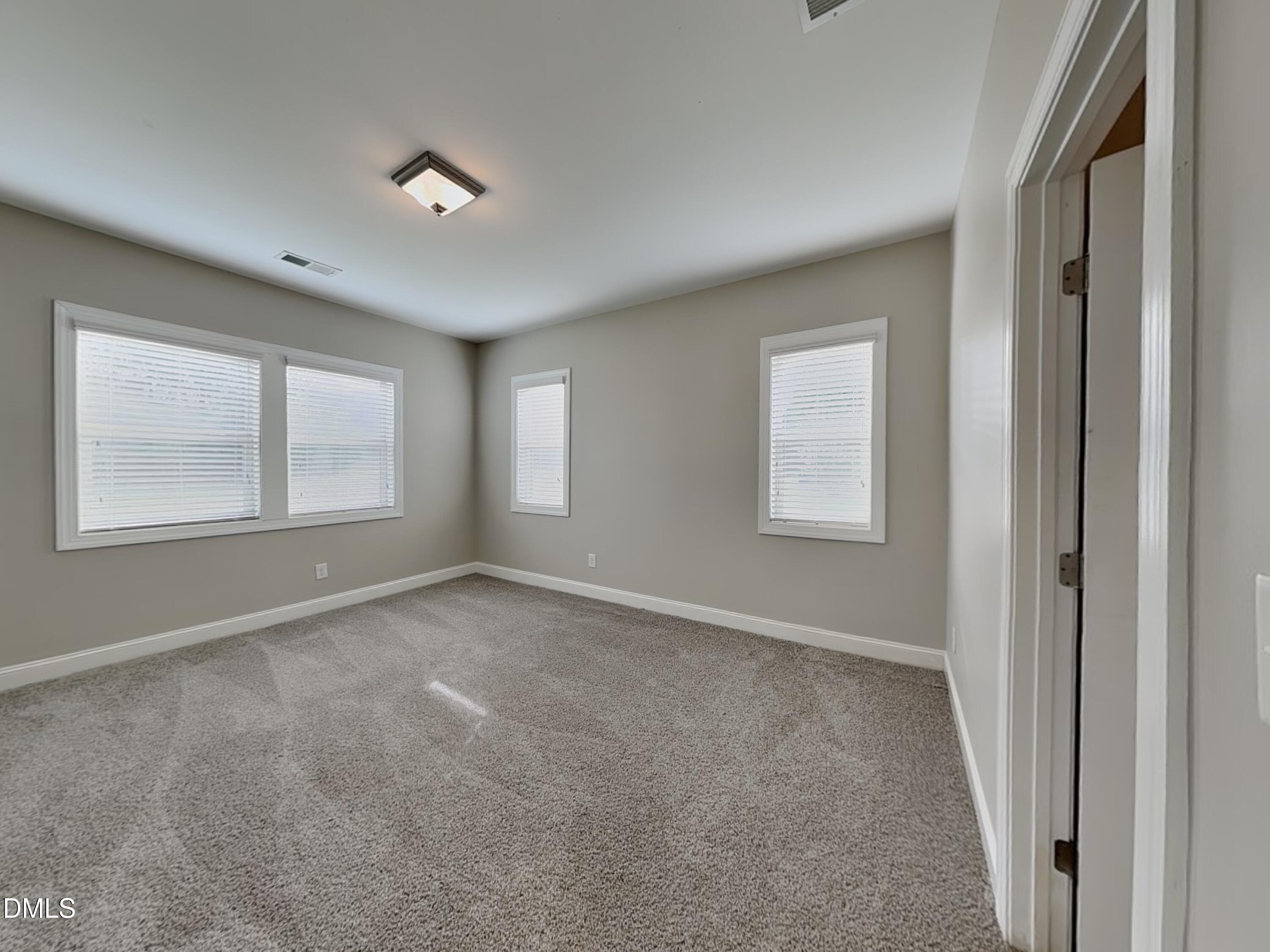 70 Leaf Spring Way Youngsville, NC 27596 - Photo 6 of 16 a view of an empty room with a window