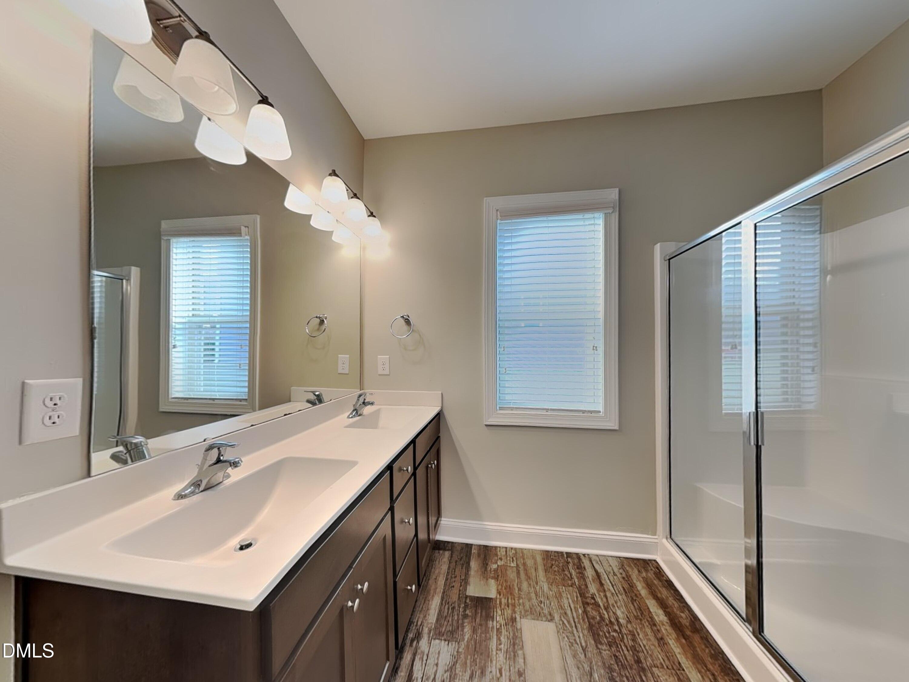 70 Leaf Spring Way Youngsville, NC 27596 - Photo 7 of 16 a bathroom with a sink a mirror and a shower