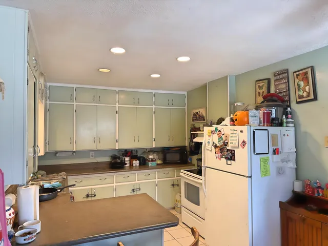 a kitchen with refrigerator and cabinets