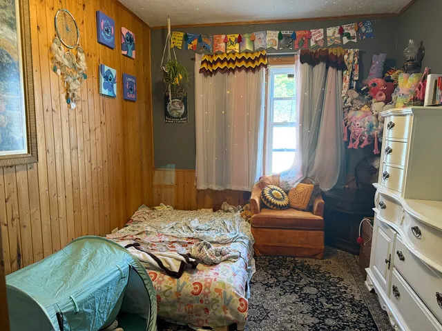 a bedroom with a bed and a couch