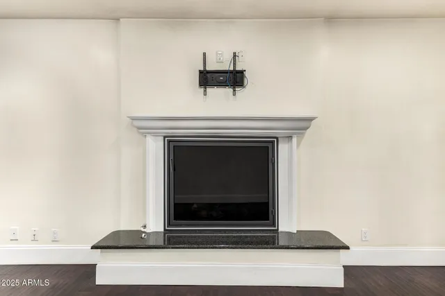 wooden floor in an empty room with a fireplace