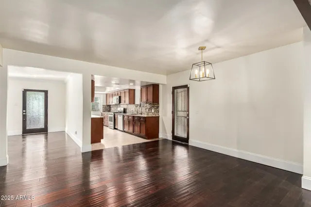 a kitchen with stainless steel appliances granite countertop a sink stove and cabinets