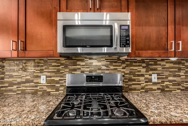 an empty room with a window and a ceiling fan