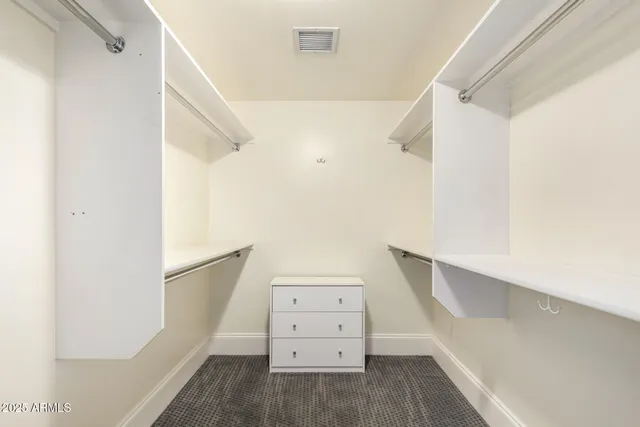 an empty room with a ceiling fan and window