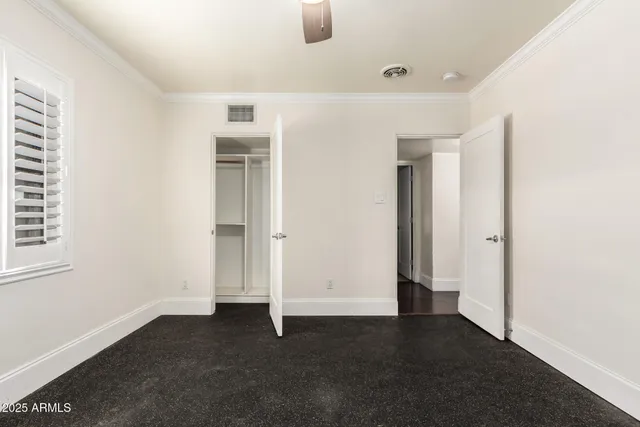 a bathroom with a granite countertop sink toilet mirror and shower
