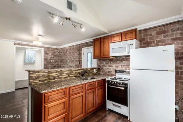 a view of a room with wooden floor and a window