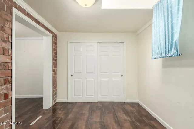 a bathroom with a granite countertop sink a toilet a mirror and shower