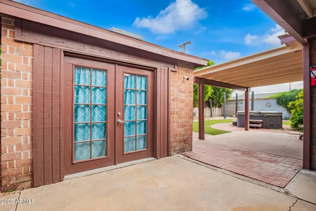 a view of a house with a yard and tree