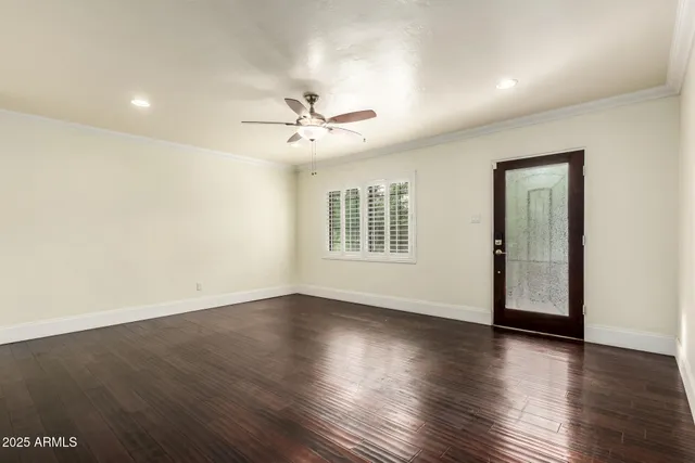 a view of an empty room with wooden floor