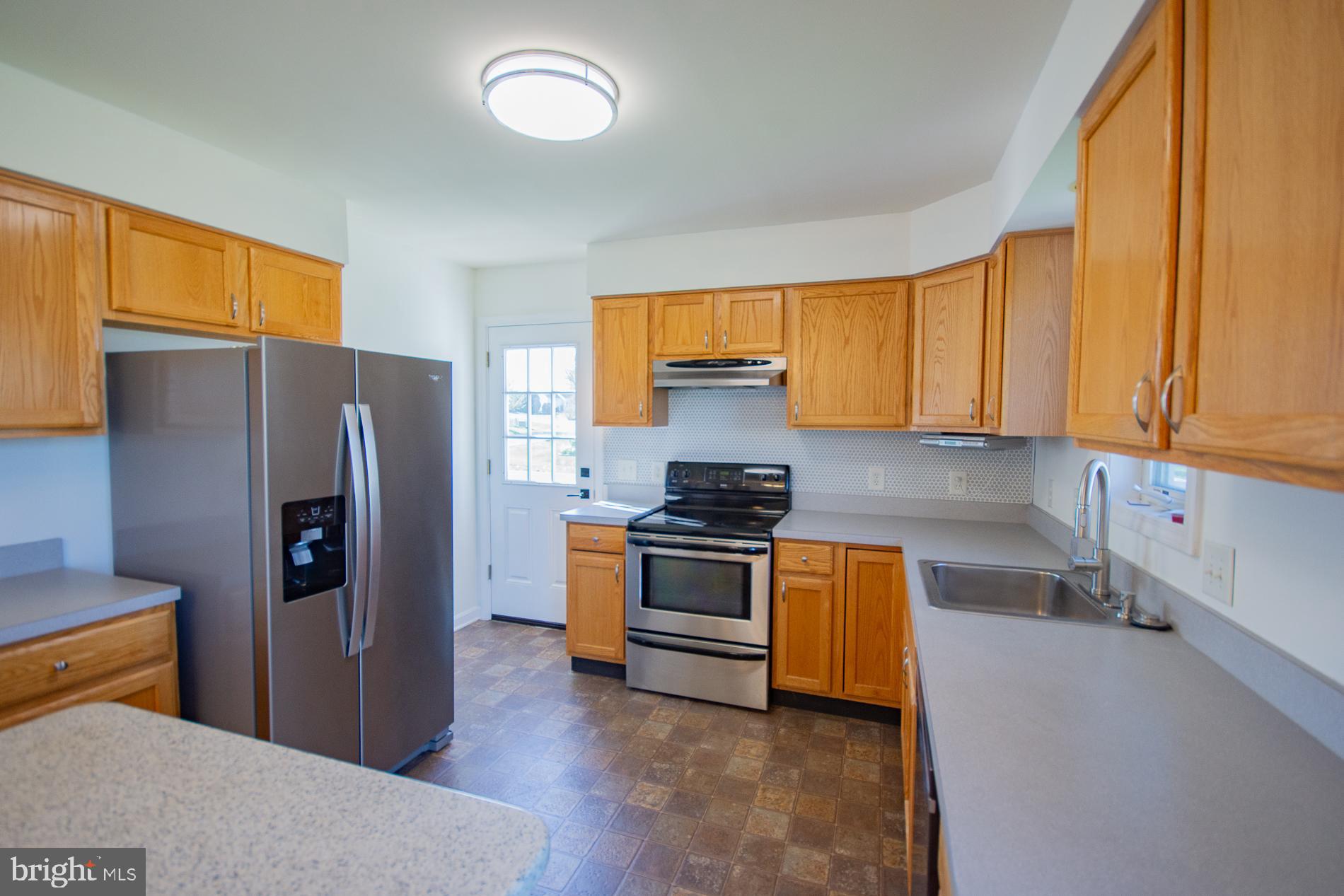 40 Stiles Way Ranson, WV 25438 - Photo 13 of 44 a kitchen with stainless steel appliances granite countertop a refrigerator and a stove top oven