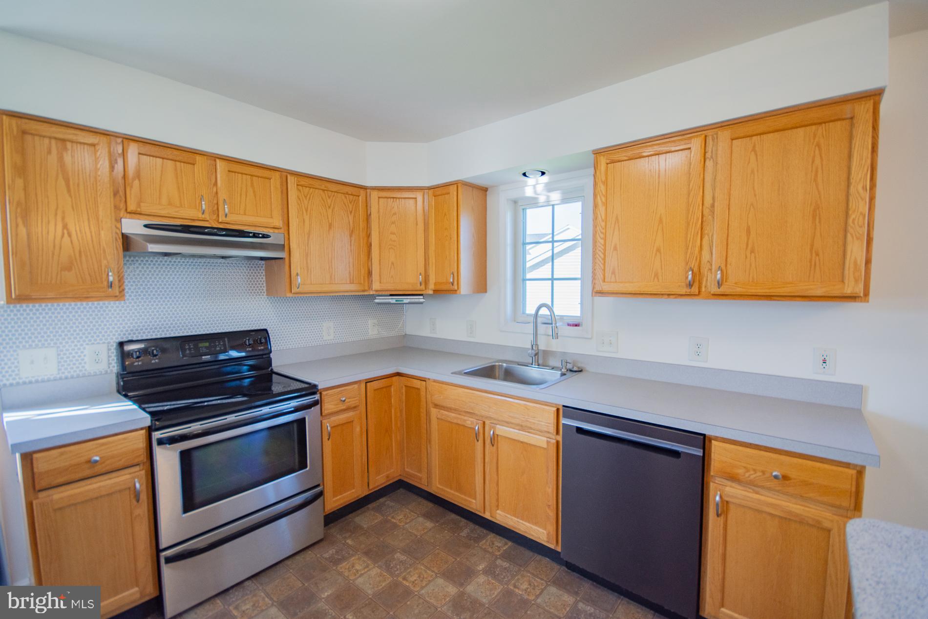 40 Stiles Way Ranson, WV 25438 - Photo 15 of 44 a kitchen with stainless steel appliances granite countertop a sink stove and microwave