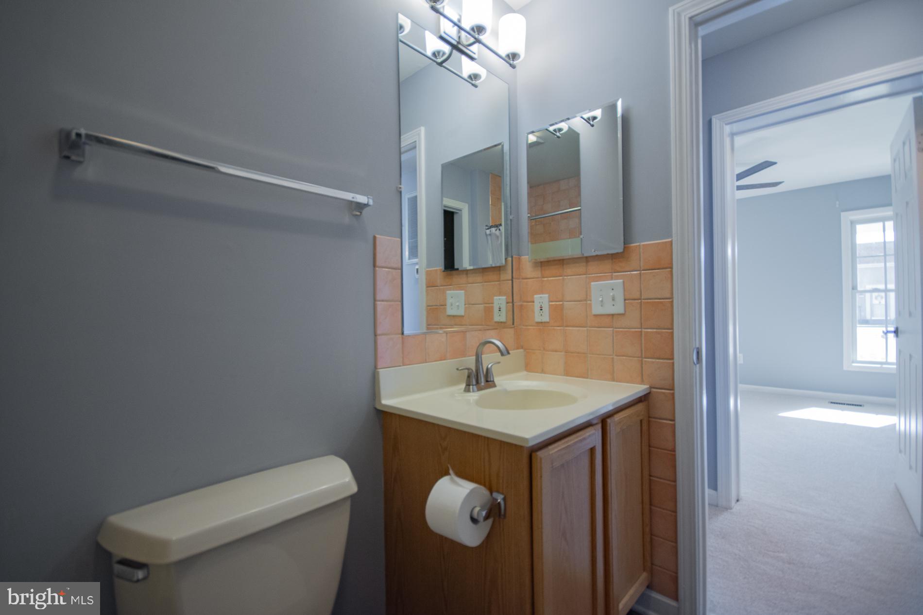 40 Stiles Way Ranson, WV 25438 - Photo 20 of 44 a bathroom with a sink toilet and mirror