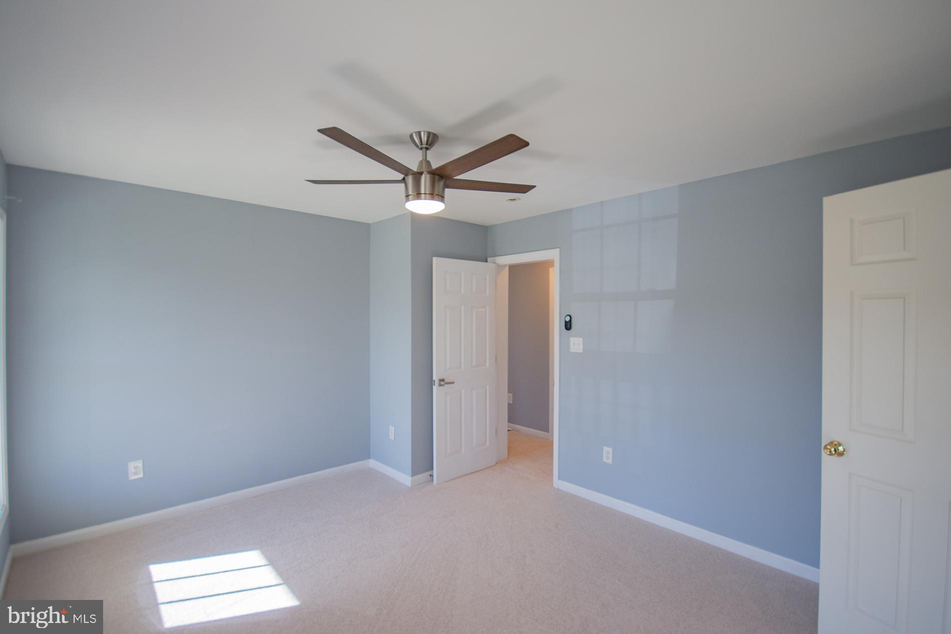40 Stiles Way Ranson, WV 25438 - Photo 23 of 44 an empty room with a window and a fan