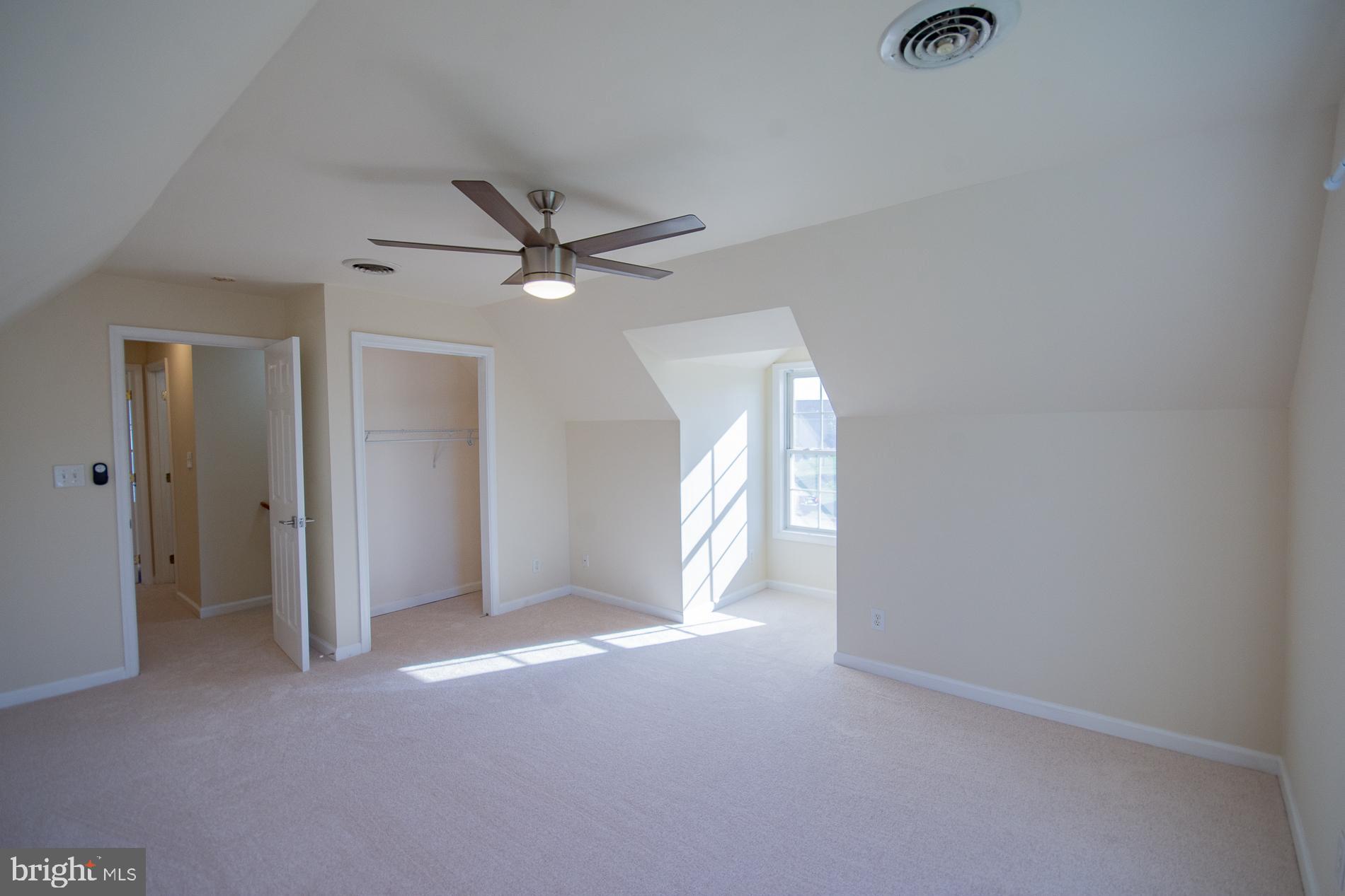 40 Stiles Way Ranson, WV 25438 - Photo 35 of 44 an empty room with a ceiling fan and a window