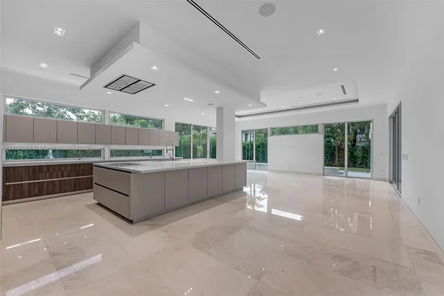a kitchen with stainless steel appliances granite countertop a sink and a large window