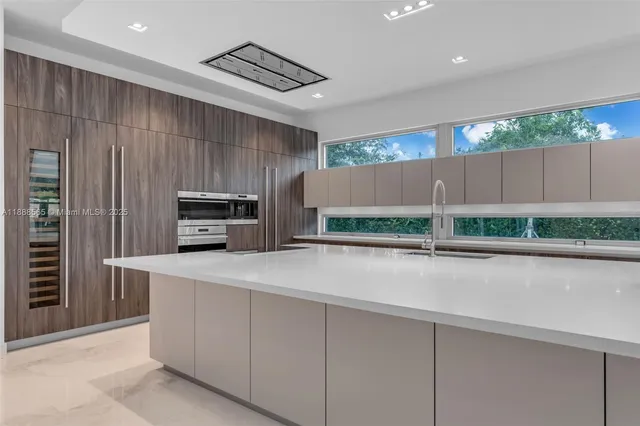 a kitchen with stainless steel appliances a refrigerator and a stove