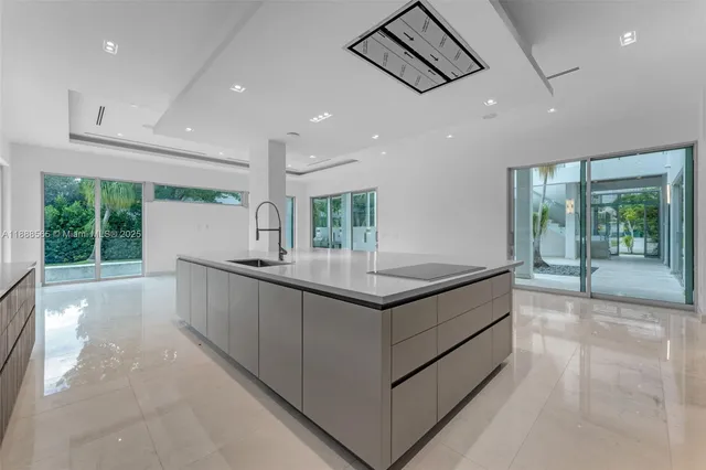 a view of a kitchen with a sink and a large window