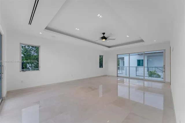 a view of balcony with two chairs and a large window