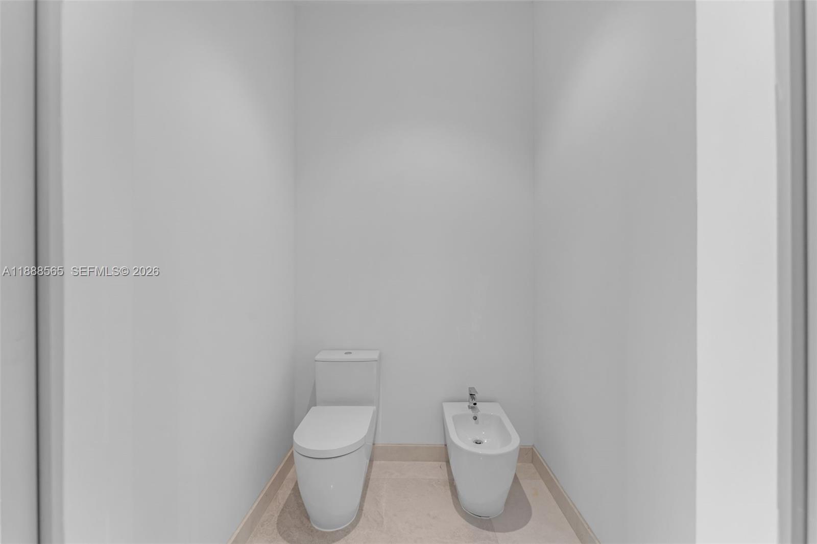 9101 Southwest 69th Court Pinecrest, FL 33156 - Photo 38 of 69 a white toilet sitting next to a white wall